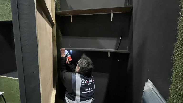 a man installing timber black shelves